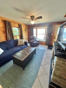 a living room with a couch and a table at CAMP MARCY LIMIT 8 cottage in Standish