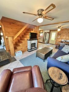 a living room with a couch and a fireplace at CAMP MARCY LIMIT 8 cottage in Standish +16 photos