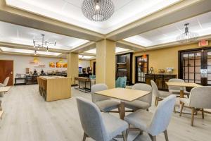 a lobby with tables and chairs and a cafeteria at Comfort Inn & Suites Chestertown in Chestertown