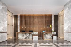 a rendering of a lobby with a reception desk at Home2 Suite by Hilton Wuhan Economic Development Zone in Wuhan