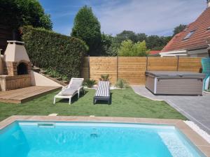 a small backyard with a swimming pool and a grill at Spassionnement pool in Jouy-le-Moutier
