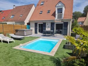 a swimming pool in the yard of a house at Spassionnement pool in Jouy-le-Moutier