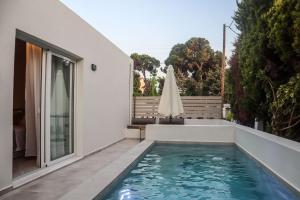 a swimming pool in the backyard of a house at Rhotheon Suites in Ialysos Rhodes - private pool in selected rooms in Ialysos