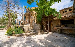 an old stone house with stairs in a yard at 1 Bedroom Pet Friendly Home In Poljica in Poljica +10 photos