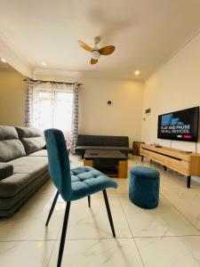 a living room with a couch and a chair at 3-Bedroom Apt with Oceanviews, 1min Walk to Beach - NYHA2 in Flic-en-Flac