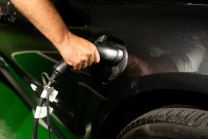 a hand is holding a car with a fuel nozzle at SH Villa Gadea in Altea