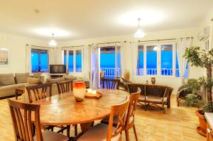 a dining room and living room with a table and chairs at Parys Villas in Tsilivi