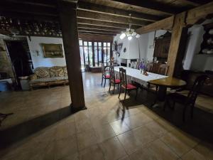 a kitchen and dining room with a table and chairs at Casa Vadim in Turda