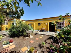 a yellow house with a courtyard in front of it at Villa Asunción D in Breña Baja +19 photos