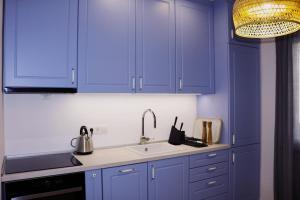 a kitchen with blue cabinets and a sink at Apartment Lavander in Novalja