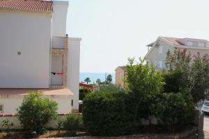 a group of buildings with bushes and trees at Apartment Lavander in Novalja