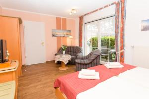 Postel nebo postele na pokoji v ubytování Hotel Garni Am Deich