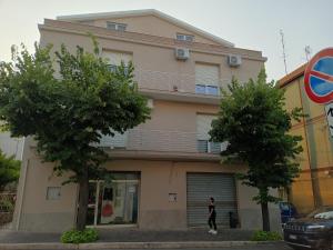 a woman walking in front of a building at B&B Lo Scrigno in Vasto