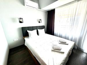 a bedroom with a bed with two towels on it at Апартамент СВЕТИ ВЛАС 1 in Sveti Vlas