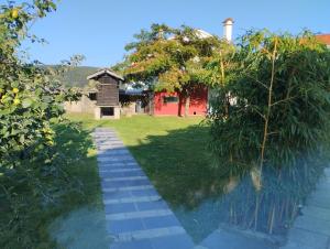 a garden with a brick path leading to a house at Casa de Valeria in Tomiño
