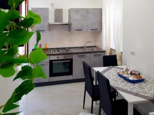 a kitchen with a table and a stove and a table and chairs at Nido nel Borgo in Acerenza