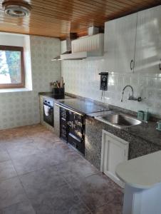 a kitchen with a sink and a counter top at Casa de Valeria in Tomiño