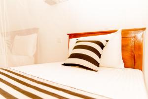 Postel nebo postele na pokoji v ubytování Aroma Heaven Homestay