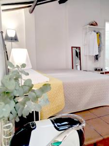 a room with a bed and a scooter in front of it at Center Vicolo Suite Apartment with Parking in Modena