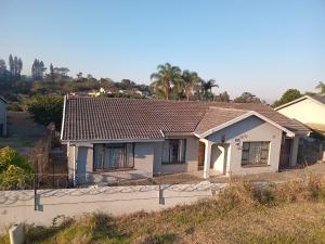 a white house with a brown roof at Gabade Guest House 2 in KwaDukuza