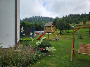a playground in a yard with a slide at Apartamenty Sielska 102 in Szlachtowa