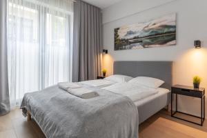 a bedroom with a large bed and a large window at Widokowe wzgórze - Sun&Sport in Szczyrk