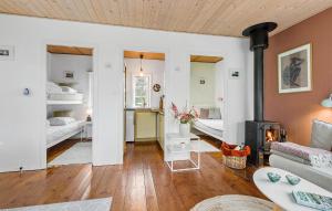 a living room with a couch and a fireplace at 2 Bedroom Cozy Home In Allinge in Allinge +11 photos