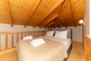 a bedroom with a bed with white towels on it at Mirabilis Suites in Vasiliki