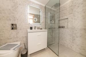 a bathroom with a shower and a sink and a toilet at Mirabilis Suites in Vasiliki +50 photos