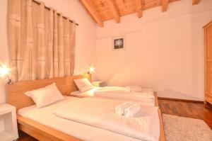 a bedroom with two beds with towels on them at Apartment Golfski - by Alpen Apartments in Zell am See