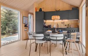 a kitchen with a table and chairs in a room at 3 Bedroom Amazing Home In Stege in Stege