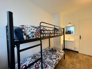 a bedroom with two bunk beds in a room at De Gaulle - Parade 24h - Parking - 6 pers in Le Mans