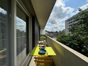 a row of tables on the balcony of a building at De Gaulle - Parade 24h - Parking - 6 pers in Le Mans