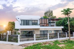 a house with a fence in front of it at Xenia House Cao Bang City in Cao Bằng