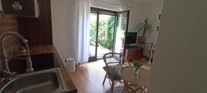 a kitchen with a table and a small table with chairs at Ferienhaus Pieschl in Keutschach am See
