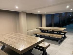 two picnic tables in a room with a view at C&C Guest Lodge in Roodepoort