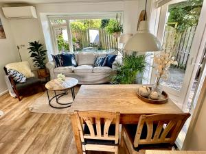 a living room with a table and a couch at Vakantiehuis Flori in Bergen