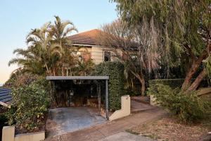 a building with a gate in front of a house at Coogee Treetops in Sydney