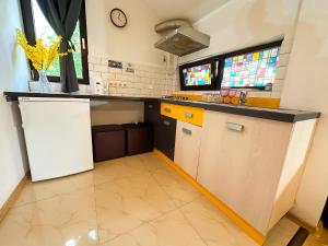 a kitchen with a counter and a refrigerator at Hamilton Apartment in Craiova +17 photos