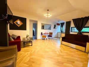 a living room with a couch and a table at Hamilton Apartment in Craiova