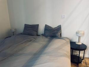 a bed in a bedroom with two pillows on it at Explore Stockholm Old Town in Stockholm +3 photos
