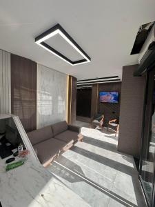a living room with a couch and a television at Luxury Life Suites in Istanbul