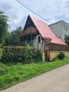 a house with a red roof on the side of a road at Chatka Terezka in Žilina