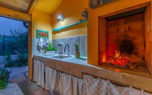 a bathroom with a fireplace with a sink in front of it at Istriensonne 0767 - Villa Sunrise Medulin in Šikići