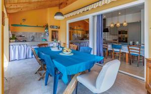 a dining room with a blue table and chairs at Istriensonne 0767 - Villa Sunrise Medulin in Šikići +46 photos