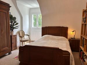 a bedroom with a bed and a chair and a window at 763 - Maison bretonne en bord de mer in Erquy