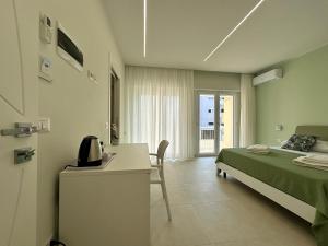 una camera con letto e scrivania con telefono di Pasitea Tropea a Tropea