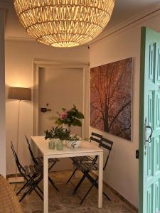a dining room with a table with chairs and a chandelier at Casona típica cántabra cerca de la playa de Gerra in La Revilla +17 photos