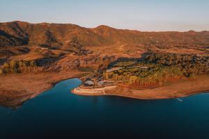 an island in the middle of a body of water at Get Hotel Molvento, AKEN SOUL Collection in Villa General Belgrano