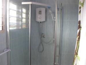 a shower in a blue tiled bathroom with a shower at Ghouse room A Ideal For Friends family And Corporate in Lateman +31 photos